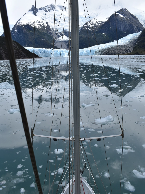 Navigating the Chilean Fjords and Glaciers on the Ksar Sailboat Embark on an exciting sports sailing adventure to the Chilean fjords aboard the Ksar Sailboat! Our expeditions are tailored exclusively for sailing enthusiasts, offering unique experiences in an awe-inspiring environment. Whether you're an experienced sailor or a keen beginner, our sports sailing trips invite you to explore the majestic Chilean fjords from a completely new perspective. On the Ksar Sailboat, each journey is an opportunity to enjoy sailing at its finest. Our highly trained team ensures your experience on board is safe, thrilling, and rewarding as you immerse yourself in the natural beauty of the Chilean fjords. From the majestic Darwin Range to the imposing glaciers and unique wildlife, our sports sailing trips allow you to explore these stunning landscapes actively and passionately. Prepare to challenge your sailing skills and dive into the pristine nature of the Chilean fjords on an unforgettable sports adventure aboard the Ksar Sailboat. Discover the Majestic Darwin Range The Darwin Range, located in the heart of the Alberto de Agostini National Park on the island of Tierra del Fuego, rises impressively within the Chilean landscape. This natural treasure, part of the great Andes Mountains, remains in a pristine state, marked by peaks that reach notable heights, with Mount Shipton standing tall at 2469 meters above sea level, the highest point of the Range on the island. As we sail west through the Beagle Channel, the mountains rise higher, signaling our imminent arrival at the majestic Darwin Range. In this magnificent setting, the "senos" glaciers advance continuously, accumulating snow and ice in a perpetual cycle. We'll venture into the Seno Pía and España fjords, and if weather conditions permit, we'll circle around Isla Gordon to discover its charming coves. Unforgettable Natural Spectacles Within the fjords, we'll witness one of nature's most sublime spectacles. The snow-capped mountains and massive glaciers will take your breath away, while curious birds welcome us without fear. We'll have the opportunity to disembark and explore this wild environment, delving into the forest and roaming the pristine shores. Life pulses in every corner, and approaching the glaciers allows us to witness the impressive sight of seracs breaking off and crashing into the water with a thunderous roar. From Ushuaia to Puerto Williams After organizing our gear on board, we'll formalize our departure with the authorities before embarking on our journey to Puerto Williams, where we'll complete Chile's immigration and customs procedures. After about 4 to 5 hours of sailing, we'll manage our entry into Chile and request permission to sail in the fjord region, known for being the authorized territory for sports navigation. Our route takes us westward, exploring the Beagle Channel and passing iconic places like the Murray Channel, Lapataia Bay, and Yendegaia Bay, hoping to find refuge in Caleta Olla if the weather permits. Here, we can explore a nearby glacier just a short walk away. We'll continue our journey, sailing through the Beagle's Northwest Arm, admiring majestic glaciers like Italia, Alemania, and Romanche. Our next stop could be in Julia, or within the Pía fjord, where we'll marvel at the grandeur of the glaciers extending to the fjord's edge. Ventisquero España and Beyond In the España fjord, the impressive Ventisquero España, standing at an imposing 450 meters, will leave us breathless. We'll also witness the grandeur of other glaciers, with ice tongues extending majestically to the water, providing an unparalleled spectacle. If conditions allow, we'll circle Isla Gordon to reach the Beagle's Southwest Arm through the Barros Merino Channel. Upon reaching Estero Coloane, we'll find an anchorage among mountains and islets, where we can appreciate two more magnificent glaciers up close. Continuing our journey eastward through the Beagle's Southwest Arm, we'll navigate the narrowest section of the Beagle, where currents can reach up to 5 knots. Upon reaching the eastern tip of Isla Gordon, we'll again see where the Beagle splits, heading back towards Puerto Williams. Final Stretch to Ushuaia Depending on the distances covered in previous days, we may require this additional day to complete the journey to Ushuaia, our point of arrival. As planned in advance, we'll have the opportunity to discover other sites not yet included in our route. Our direction can be adjusted during navigation to suit current conditions. Experience the thrill and beauty of sports sailing to the Chilean fjords and glaciers on the Ksar Sailboat. Join us for an unforgettable adventure exploring one of the world's most pristine and breathtaking regions.